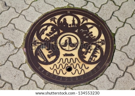 NAGOYA, JAPAN - APRIL 28: Most popular landmarks are presented on a sewer cover on April 28, 2012 in Nagoya, Japan. Decorative and colorful sewer covers are typical for cities in Japan.