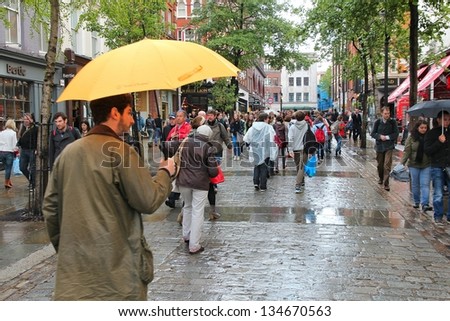 LONDON - MAY 15: People visit Covent Garden in rain on May 15, 2012 in London. With more than 14 million international arrivals in 2009, London is the most visited city in the world (Euromonitor).