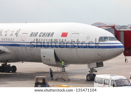 MOSCOW - MAY 12: Passengers board Air China Boeing 777 on May 12, 2012 at Sheremetyevo Airport, Moscow. It is 3rd largest airline of Asia with 49.3 million passengers carried in 2012.