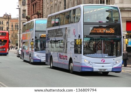 MANCHESTER, UK - APRIL 22: People ride FirstGroup city buses on April 20, 2013 in Manchester, UK. FirstGroup employs 124,000 people.
