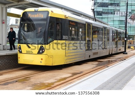 Manchester, Uk - April 22: People Board Manchester Tram On April 22, 2013 In Manchester, Uk. Manchester Metrolink Serves 21 Million Rides Anually (2011).