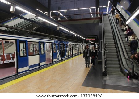 MADRID - OCTOBER 24: People exit Madrid Metro on October 24, 2012 in Madrid. Madrid Metro has annual ridership of 634 million passengers (2011).