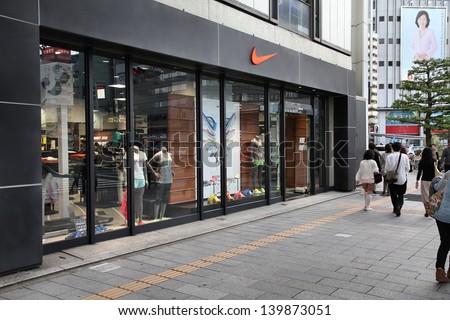 Nagoya, Japan - May 3: People Walk Past Nike Store On May 3, 2012 In Nagoya, Japan. Nike Is One Of Most Recognized Fashion Brands. It Exists Since 1964 And Had Us$ 19 Billion Revenue (2010).