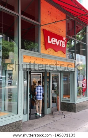 CHICAGO - JUNE 26: Man enters Levi\'s store on June 26, 2013 in Chicago. Levi\'s is an American clothing company. It exists since 1853 and had US$ 4.4bn revenue in 2010.