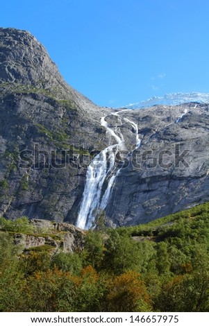 Norway, Jostedalsbreen National Park. Waterfall originating from Jostedalsbreen glacier, falling into Briksdalen valley.