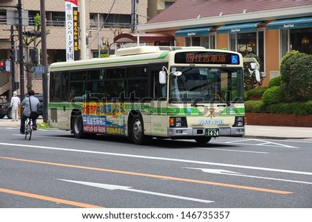 OSAKA, JAPAN - APRIL 25: People ride Hino bus on April 25, 2012 in Osaka, Japan. Hino Motors exists since 1942, employs 9.500 people (2008) and is part of Toyota Motor Company.