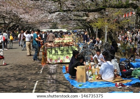 TOKYO - APRIL 12: Visitors enjoy cherry blossom (sakura) on April 12, 2012 in Ueno Park, Tokyo. Ueno Park is visited by up to 2 million people for annual Sakura Festival.