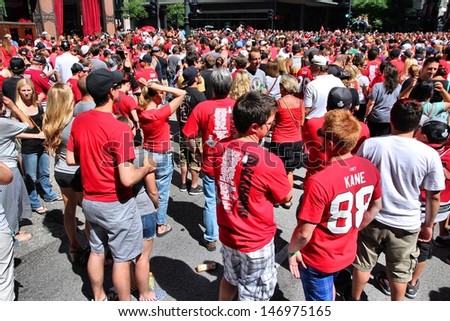 CHICAGO - JUNE 28: Blackhawks fans celebrate Stanley\'s Cup win on June 28, 2013 in Chicago. 2 million people celebrated the trophy in Chicago streets during team parade.