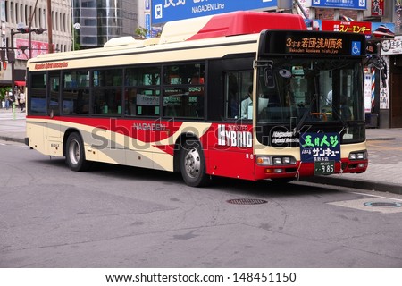 NAGANO, JAPAN - MAY 1: People ride hybrid Hino bus on May 1, 2012 in Nagano, Japan. Hino Motors exists since 1942, employs 9.500 people (2008) and is part of Toyota Motor Company.