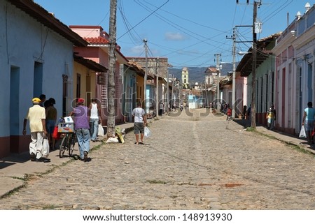 TRINIDAD, CUBA - FEBRUARY 5: People walk in the Old Town on February 5, 2011 in Trinidad, Cuba. The Old Town is UNESCO World Heritage Site and is one of most recognized places in Cuba.