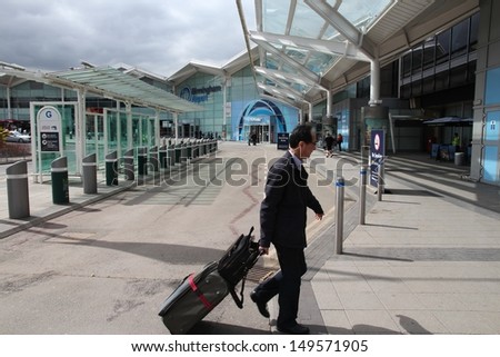 BIRMINGHAM, UK - APRIL 19: Traveler hurries on April 19, 2013 at Birmingham International Airport, UK. With 8.9 million travelers served it was the 7th busiest UK airport in 2012.