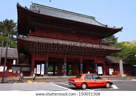 TOKYO - MAY 10: Taxi cab rides past a temple on May 10, 2012 in Tokyo, Japan. Tokyo has almost 60,000 taxi cabs, almost 5 times the number of New York City cabs.