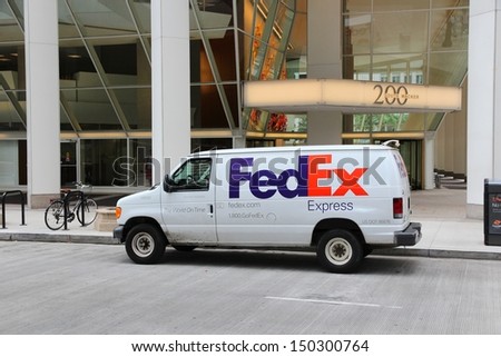 CHICAGO - JUNE 26: Fedex delivers packages on June 26, 2013 in Chicago. Fedex is one of largest package delivery companies worldwide with 300,000 employees USD 42.7 billion revenue (2012).