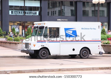 Chicago - June 26: People Walk Past Us Postal Service Truck On June 26, 2013 In Chicago. Usps Is The Operator Of The Largest Civilian Vehicle Fleet In The World.