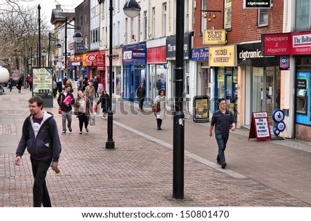 BOLTON, UK - APRIL 23: People walk along shopping street on April 23, 2013 in Bolton, UK. Bolton is part of Greater Manchester, one of largest population areas in UK (2.68m people live in the county)