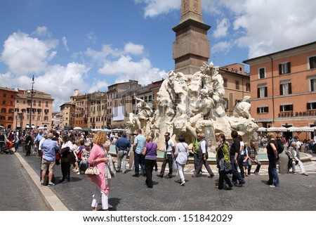 ROME - MAY 13: Tourists visit Piazza Navona on May 13, 2010 in Rome, Italy. The iconic square is one of the most visited landmarks in the world and a top tourism destination in Italy.
