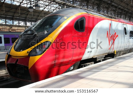 Manchester, Uk - April 23: Virgin Trains Pendolino Train On April 23, 2013 In Manchester, Uk. Virgin Trains Operates Since 1997 And As Of 2013 Uses 56 Class 390 Pendolino Train Sets.