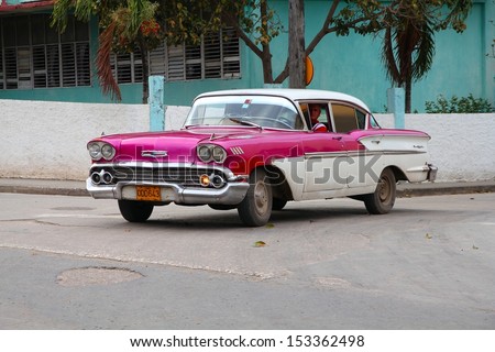 HOLGUIN, CUBA - FEBRUARY 16: Cuban drives old car on February 16, 2011 in Holguin, Cuba. Recent change in law allows the Cubans to trade cars after it was forbidden for many years.
