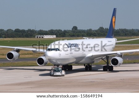 DUSSELDORF, GERMANY - JULY 8: Lufthansa Airbus A340 is pushed back on July 8, 2013 in Dusseldorf Airport, Germany. Lufthansa Group carried over 103 million passengers in 2012.