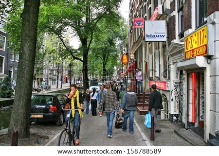 AMSTERDAM - AUGUST 28: People visit Red Light District on August 28, 2008 in Amsterdam, Netherlands. Amsterdam is the biggest Dutch city. It receives 4.6 million international visitors annually (2009)