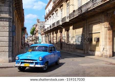 HAVANA - FEBRUARY 27: People ride Classic car on February 27, 2011 in Havana. Recent change in law allows Cubans to trade cars again. Old law resulted in very old fleet of private owned cars in Cuba.