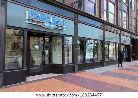 Cleveland - June 29: Person Walks Past Dollar Bank On June 29, 2013 In Cleveland. Dollar Bank Is A Mutual Bank With 50+ Branches. As Of 2009 It Was Largest Independent Mutual Bank In The Us.