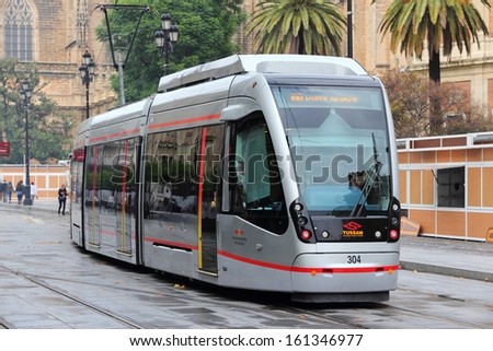 SEVILLE, SPAIN - NOVEMBER 4: People ride Tussam tram on November 4, 2012 in Seville, Spain. MetroCentro line is 1.4 km long and serves the Old Town of Seville, 4th largest city in Spain.