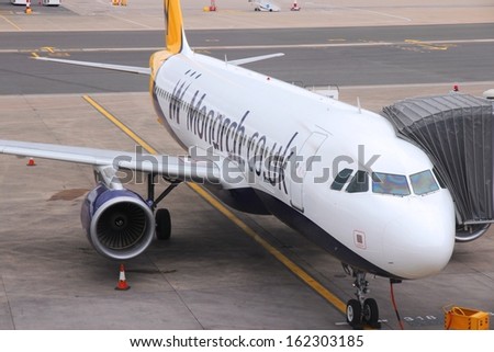 BIRMINGHAM, UK - APRIL 24: People board Monarch Airlines Airbus A320 on April 24, 2013 at Birmingham Airport, UK. Monarch carried 6.3 million passengers in 2012.