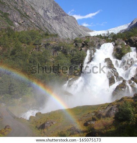 Norway, Jostedalsbreen National Park. Famous waterfall originating from Briksdalsbreen glacier in Briksdalen valley. Square composition.