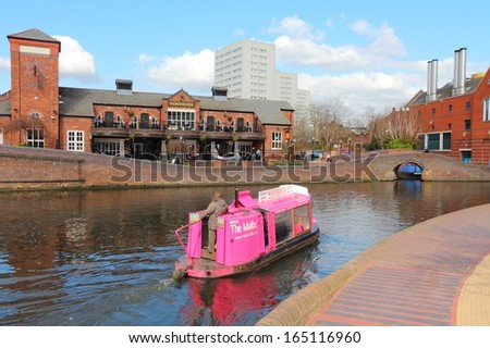 BIRMINGHAM, UK - APRIL 19: People ride a boat in the canal network on April 19, 2013 in Birmingham, UK. Birmingham is the most populous British city outside London with 1.07 million residents.