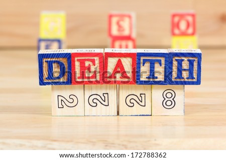 Wooden blocks with letters. Educational toy concept - children learning about death.