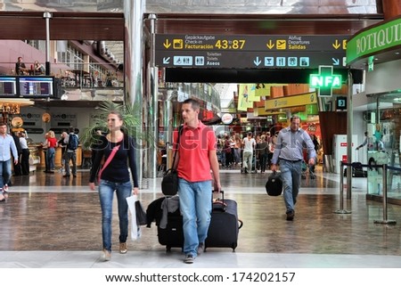 TENERIFE, SPAIN - NOVEMBER 2, 2012: Passengers hurry in Tenerife South Airport. With 8.7m passengers in 2011 it was busiest airport in Tenerife and 7th busiest in Spain.