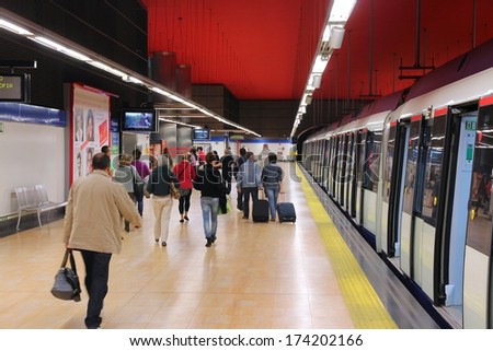 MADRID, SPAIN - OCTOBER 23, 2012: People exit Madrid Metro train. Madrid Metro has annual ridership of 634 million passengers (2011).