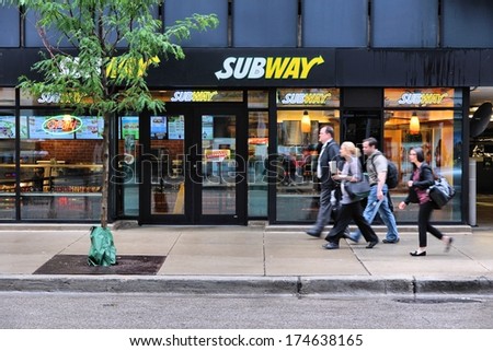 CHICAGO, USA - JUNE 26, 2013: People walk past Subway sandwich store in Chicago. Subway is one of fastest growing restaurant franchises with 39,747 restaurants in 101 countries.