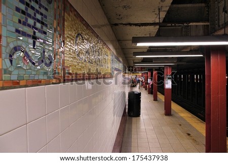 NEW YORK, USA - JULY 5, 2013: People wait at Canal Street subway station in New York. With 1.67 billion annual rides, New York City Subway is the 7th busiest metro system in the world.