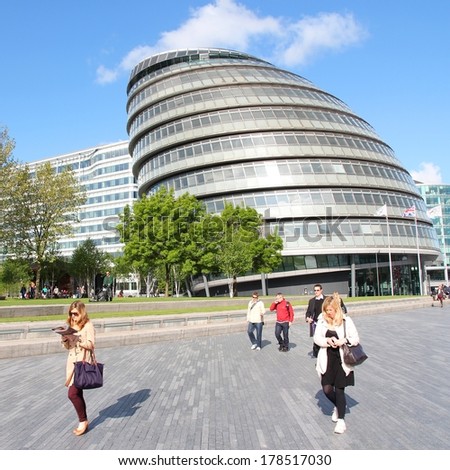 LONDON, UK - MAY 16, 2012: Tourists walk next to the City Hall (GLA) in London. With more than 14 million international arrivals in 2009, London is the most visited city in the world (Euromonitor).