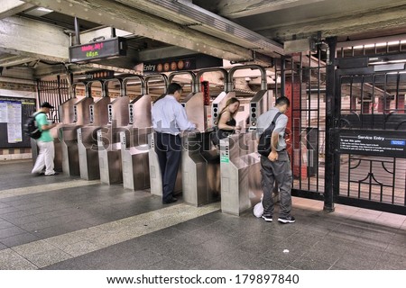 NEW YORK, USA - JULY 1, 2013: People enter a subway station in New York. With 1.67 billion annual rides, New York City Subway is the 7th busiest metro system in the world.