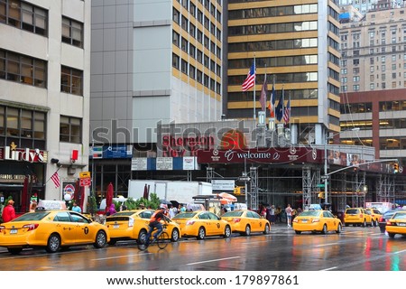 NEW YORK, USA - JULY 1, 2013: People walk along taxi filled 7th Avenue in New York.  As of 2012 there were 13,237 yellow taxi cabs registered in New York City.