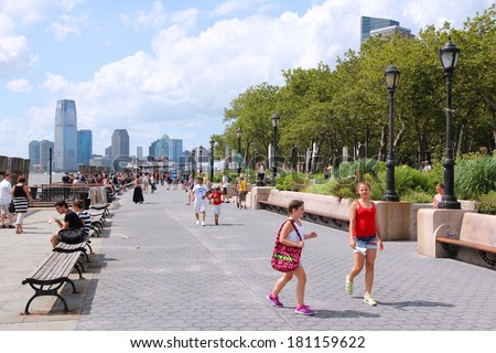 NEW YORK, USA - JULY 4, 2013: People visit Battery Park in New York. Almost 19 million people live in New York City metropolitan area.