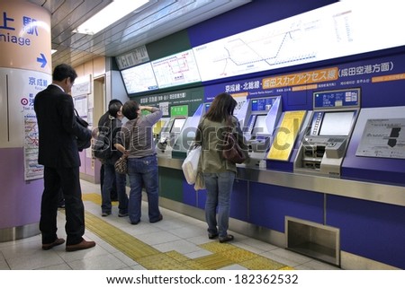 TOKYO, JAPAN - APRIL 13, 2012: People buy tickets for Toei Metro in Tokyo. With more than 3.1 billion annual passenger rides, Tokyo subway system is the busiest worldwide.