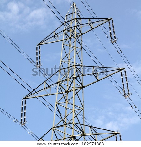 High voltage electricity pylon in Switzerland. Power grid. Square composition.