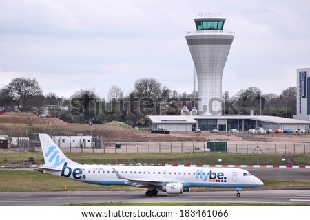 BIRMINGHAM, UK - APRIL 24, 2013: Pilots taxi Flybe Embraer E-195 at Birmingham Airport, UK. Flybe carried 7.6 million passengers in 2013.