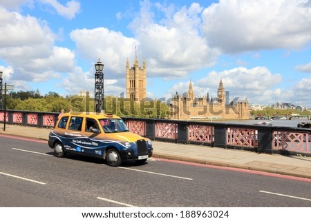 LONDON, UK - MAY 13, 2012: Taxi cab drives in London. As of 2012, there were 24,000 licensed taxi cabs in London.