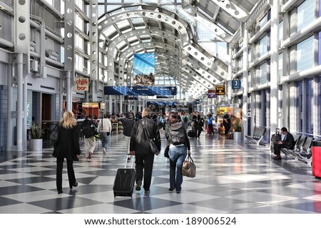 CHICAGO, USA - APRIL 1, 2014: Travelers walk to gates at Chicago O\'Hare International Airport in USA. It was the 5th busiest airport in the world with 66,883,271 passengers in 2013.