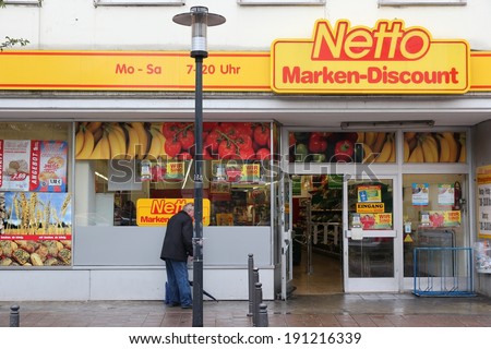 ESSEN, GERMANY - JULY 17, 2012: Person visits Netto discount store in Essen, Germany. It is part of Edeka Group, largest German supermarket corporation employing 250,000 people.