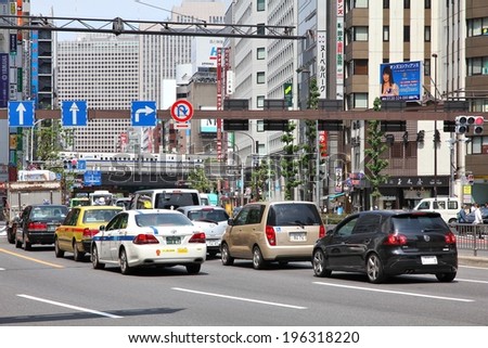 TOKYO, JAPAN - MAY 11, 2012: People drive cars in Tokyo. With 591 vehicles per capita, Japan is a country with one of highest car ownership rates.