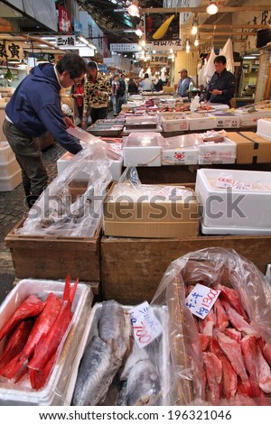 TOKYO, JAPAN - MAY 11, 2012: People visit famous Tsukiji Fish Market in Tokyo. It is the biggest wholesale fish and seafood market in the world.
