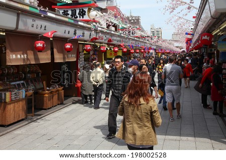 TOKYO, JAPAN - APRIL 13, 2012: Tourists visit Nakamise shopping street Asakusa in Tokyo. Tokyo is the most visited city in Japan. Japan had 8.3 million foreign visitors in 2008.