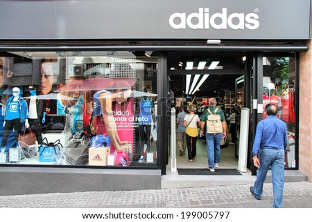 SANTA CRUZ, SPAIN - OCTOBER 27, 2012: Shoppers visit Adidas store in Santa Cruz de Tenerife, Spain. As of 2012, Adidas is the 2nd biggest sportswear manufacturer worldwide.