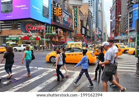 NEW YORK, USA - JULY 1, 2013: People visit Times Square in New York. Times Square is one of most recognized landmarks in the world. More than 300,000 people pass through Times Square daily.